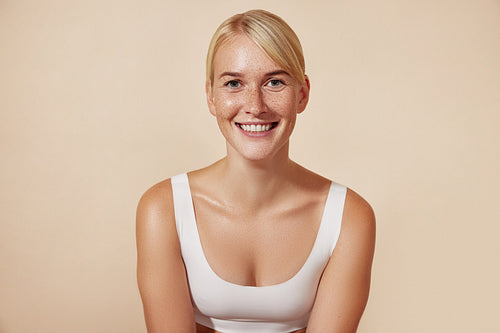 Young cheerful woman with freckles. Portrait of a smiling female with perfect skin.