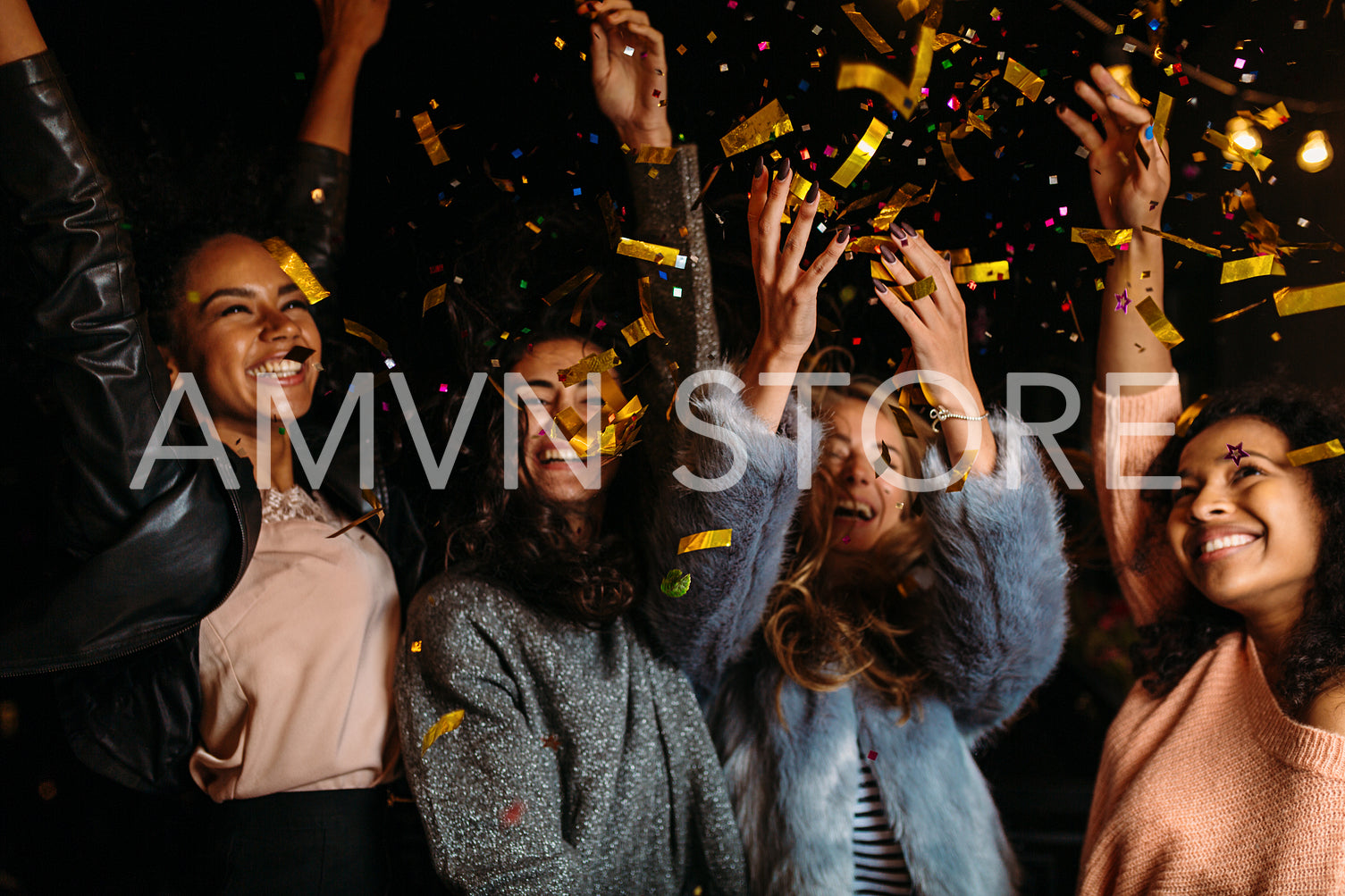 Female friends raised hands up, enjoying party outdoors	