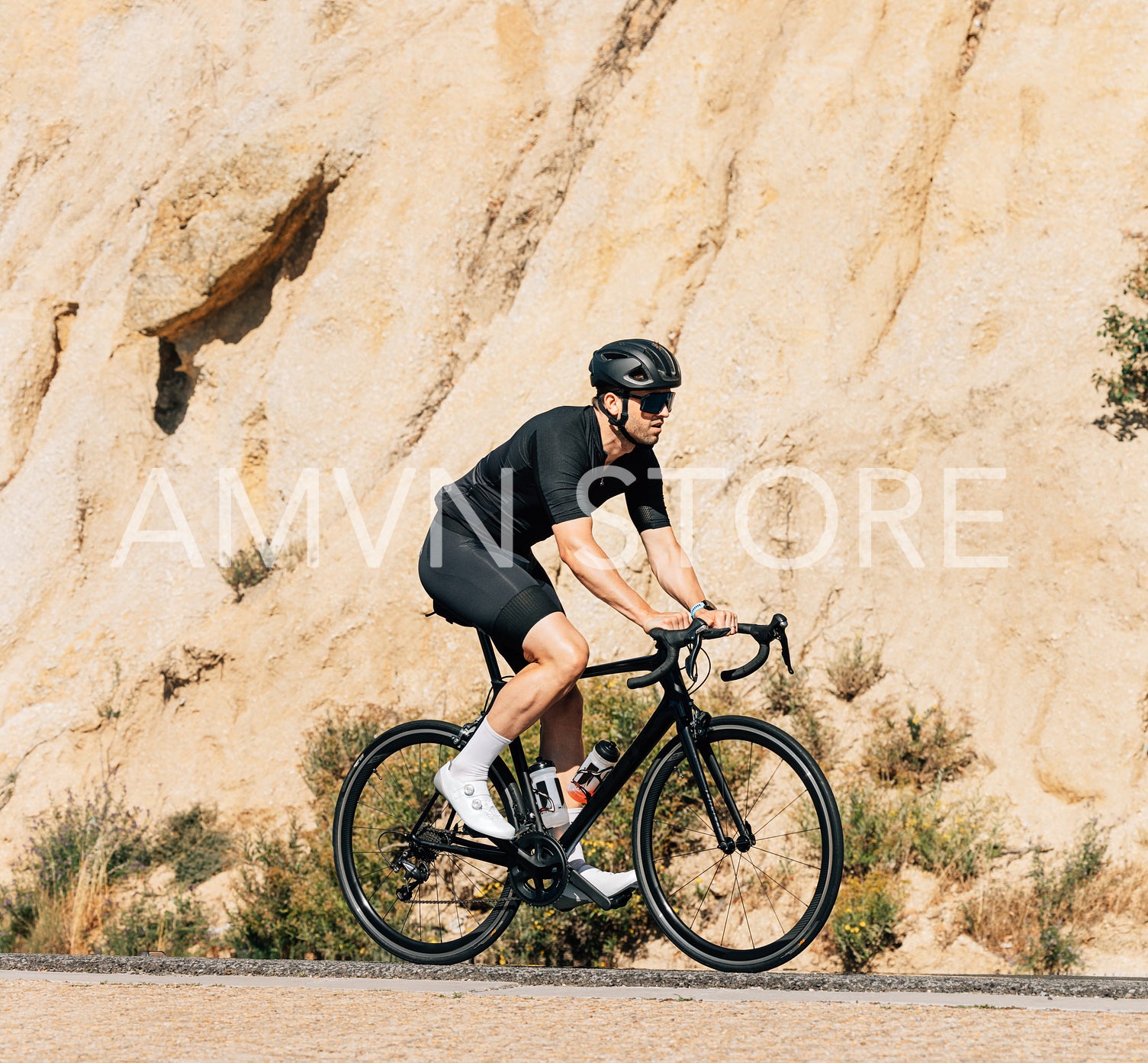 Professional triathlete in black sportswear riding road bike 