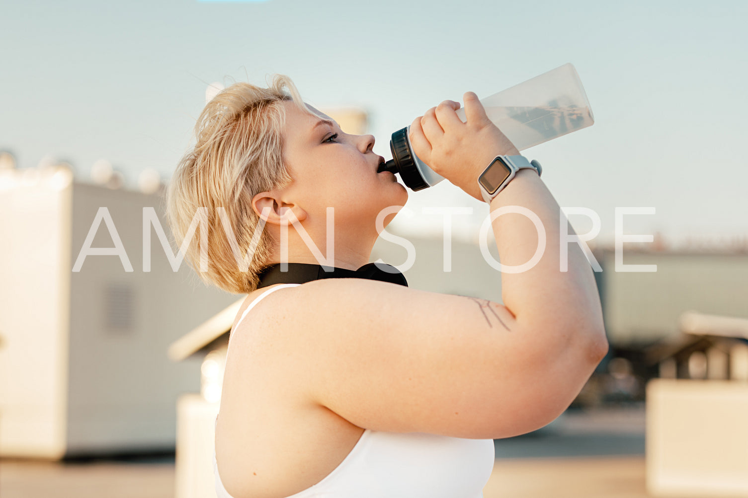 Side view of plus size woman taking a break during training