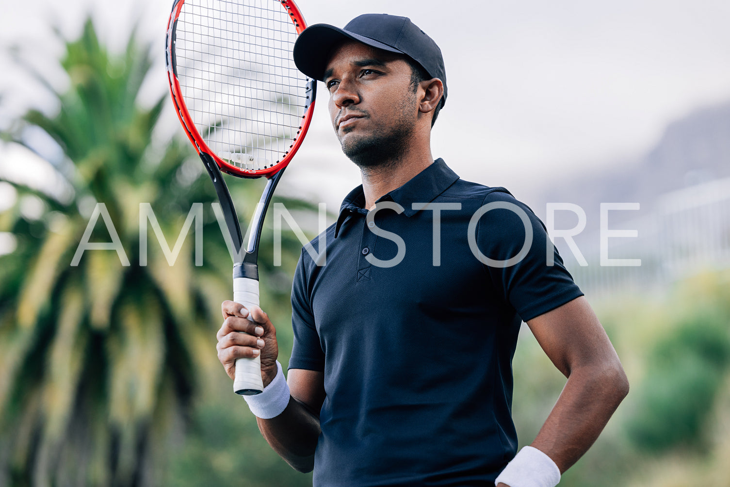 Portrait of a young tennis player with a racket