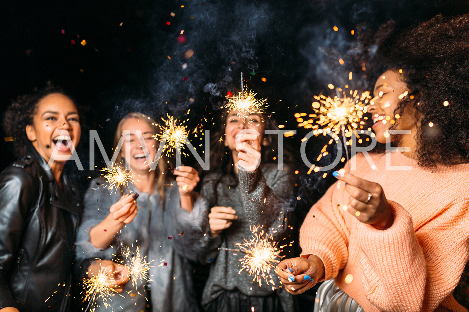 Four happy women holding sparklers, throwing confetti	