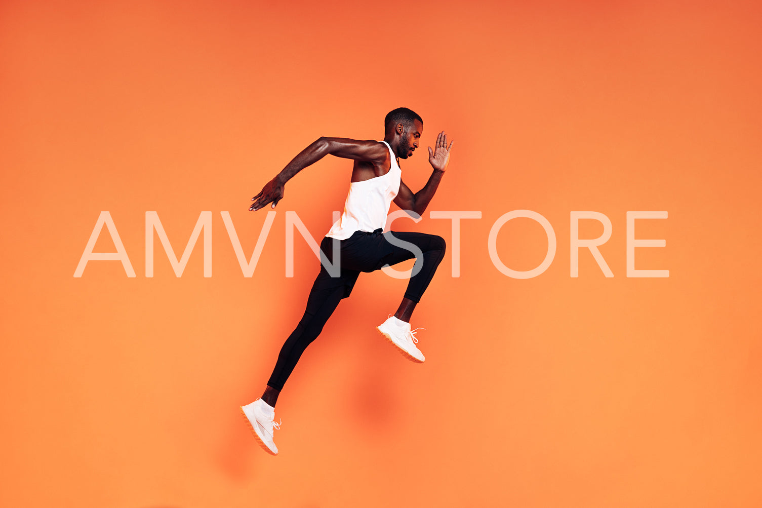 Male runner doing fitness workout. Athlete exercising over an orange background.