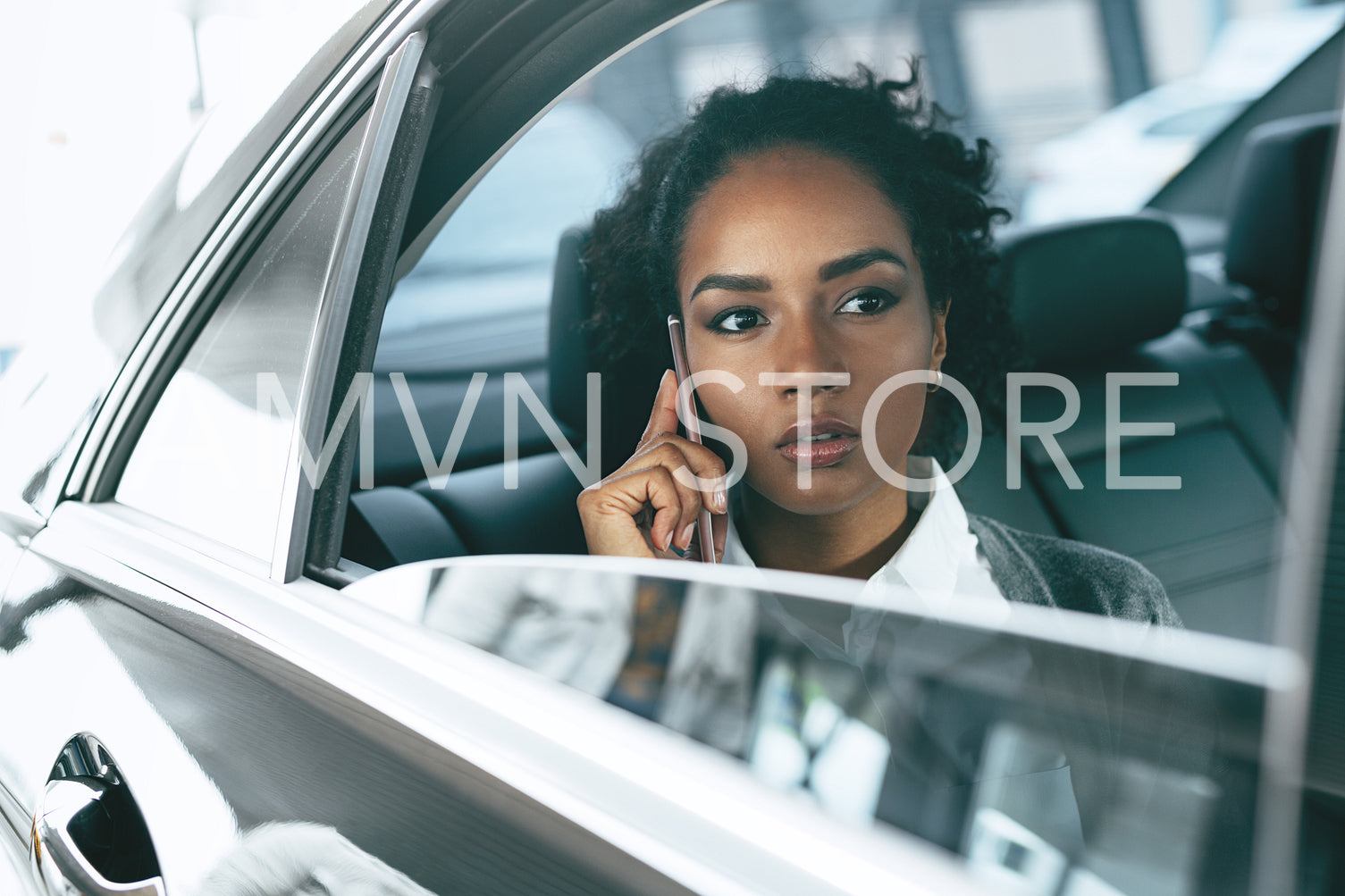 Serious businesswoman working from back seat of taxi	