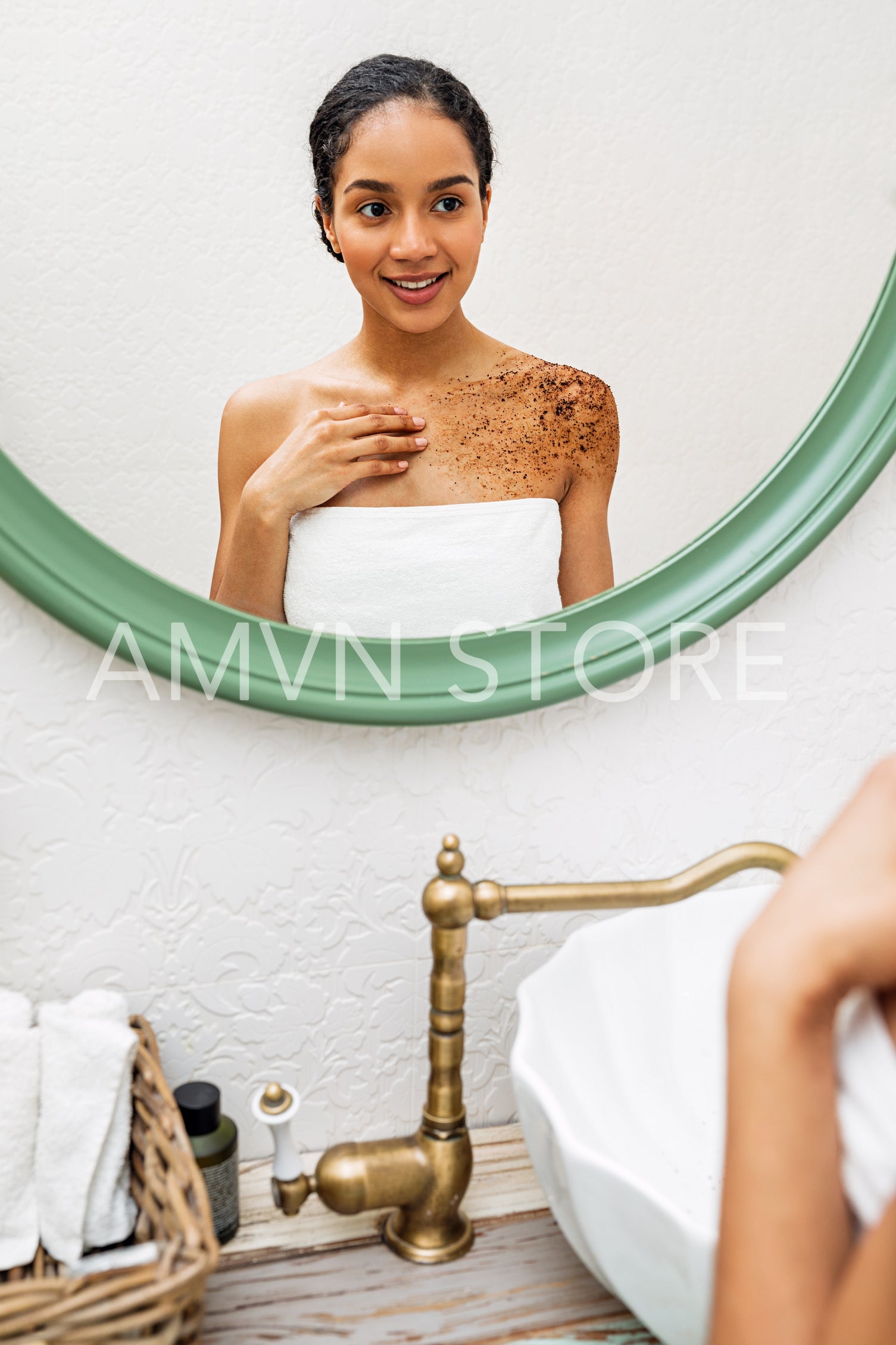 Beautiful woman applying natural scrub on her shoulder after bath	