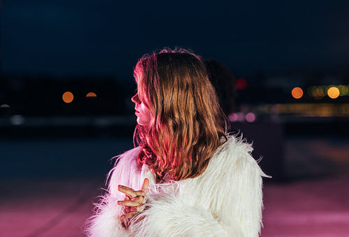 Side view of a blond girl looking away while standing outdoors