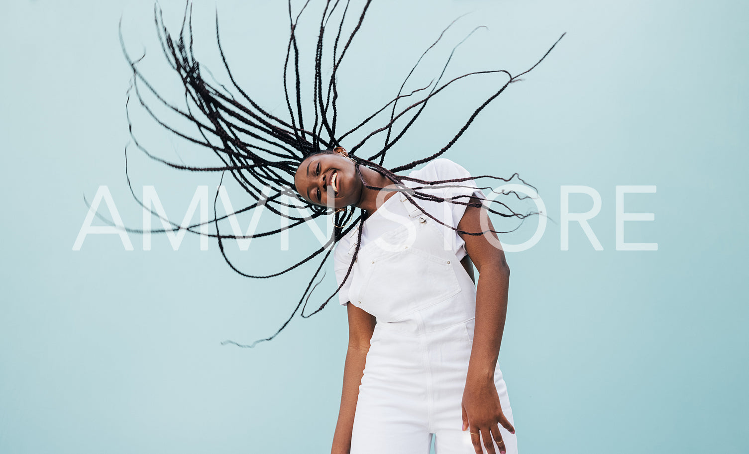 Smiling woman with long braided hair having fun outdoors