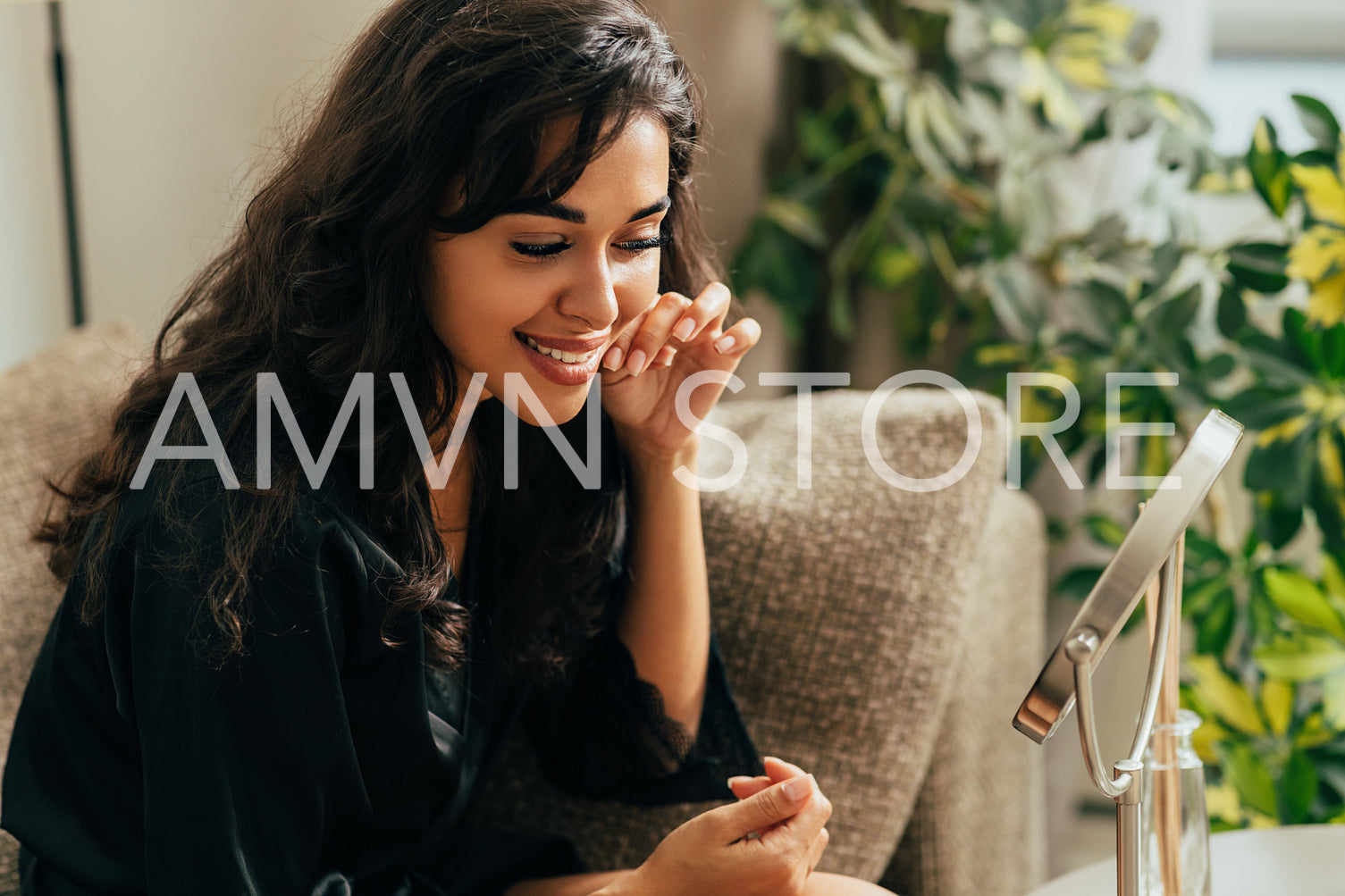 Beautiful brunette woman looking at a mirror in living room touching face