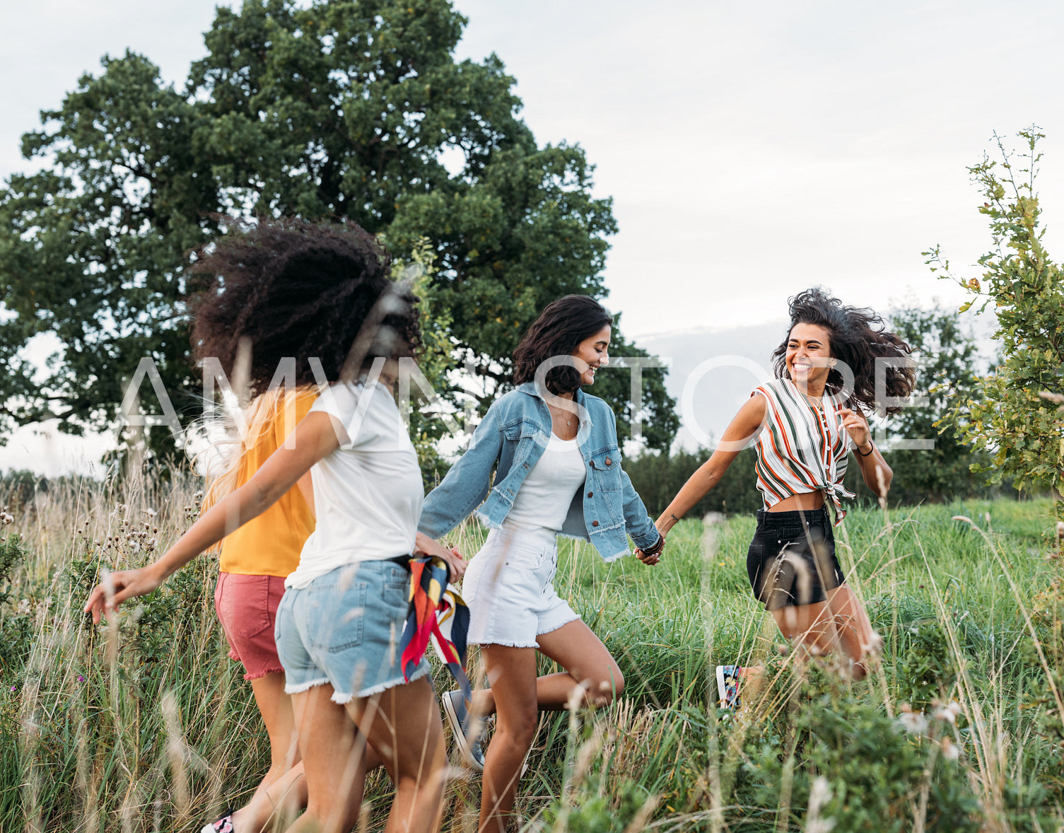 Happy females running on field enjoying summer journey