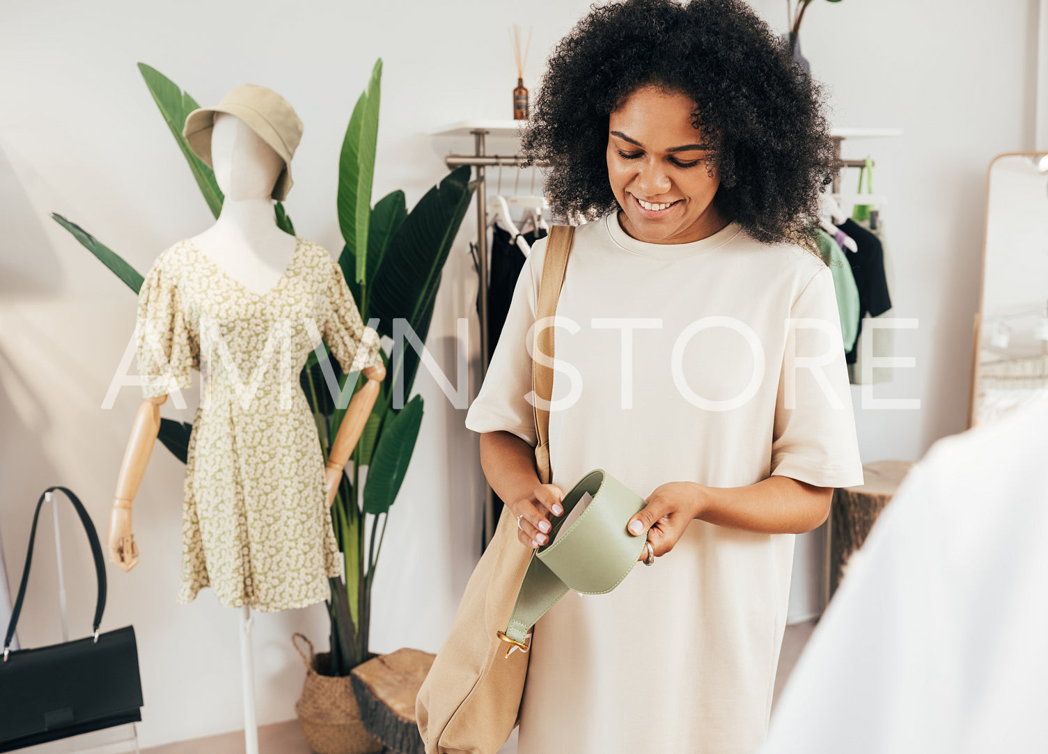 Stylish woman holding a leather belt in a boutique