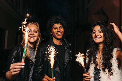 Three friends at night. People celebrating new year.