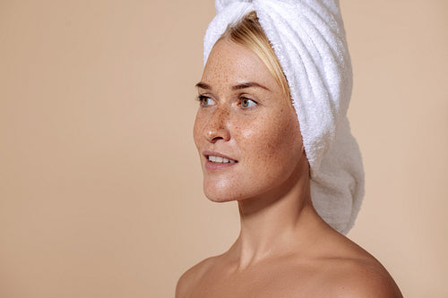 Portrait of young confident woman with freckles. Studio shot of