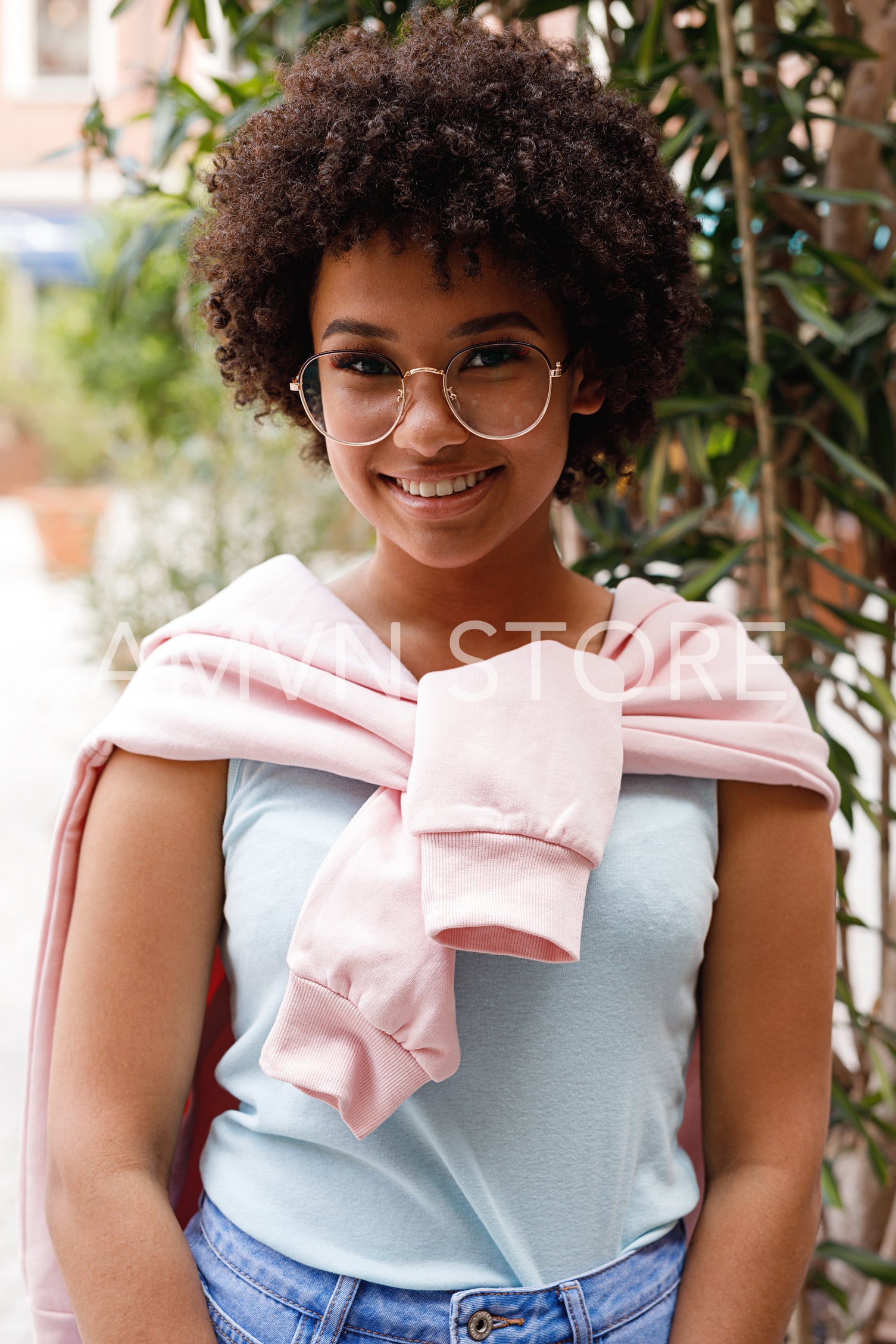 Portrait of cute smiling girl wearing casual clothes and glasses	