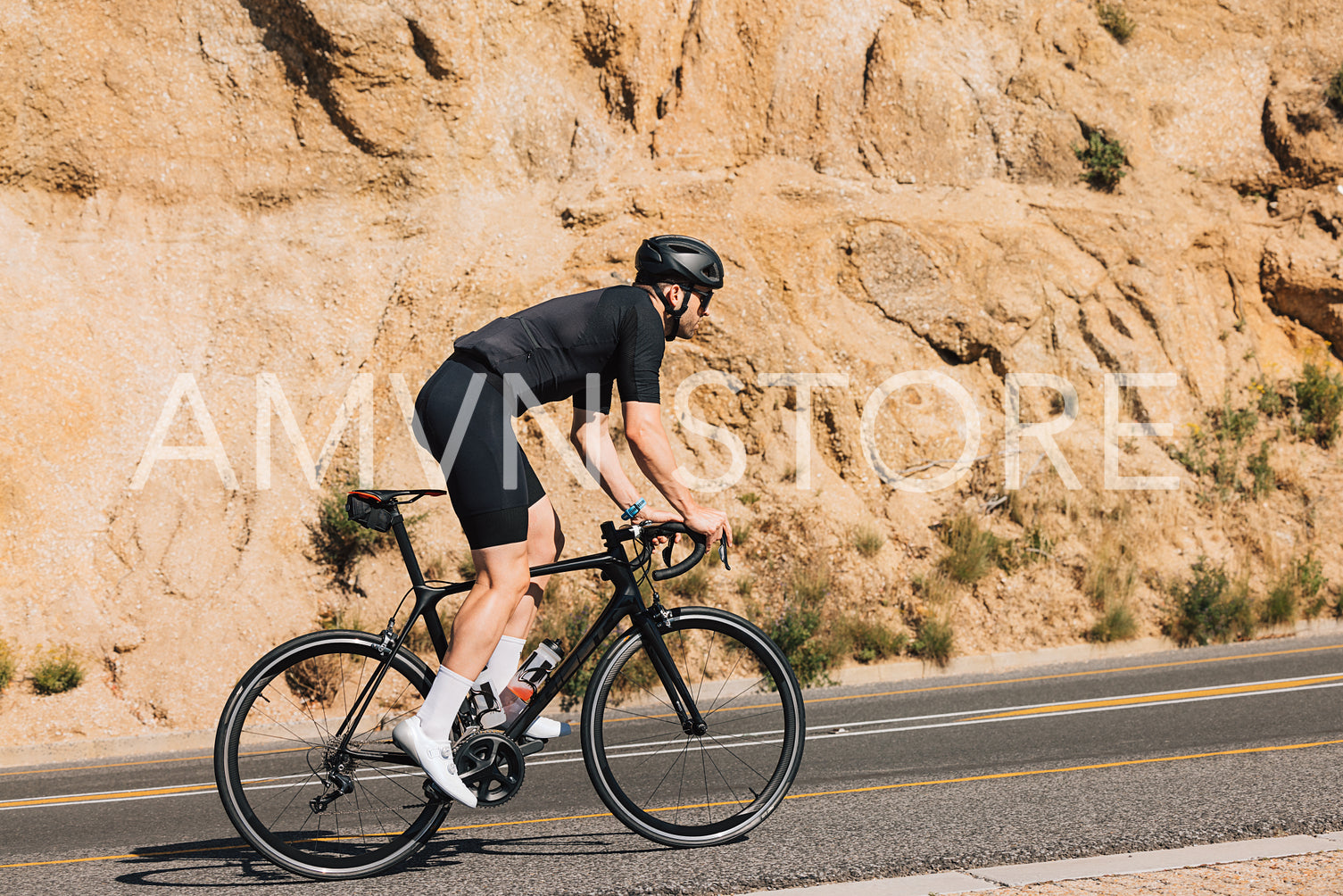 Male cyclist on his road bike doing intense training on an empty road