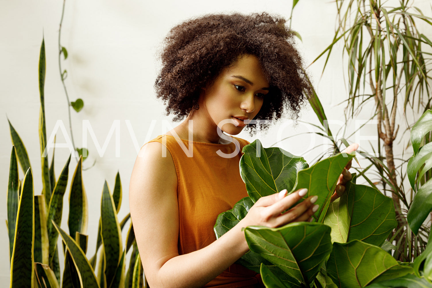 Beautiful woman botanist working at her indoor garden	