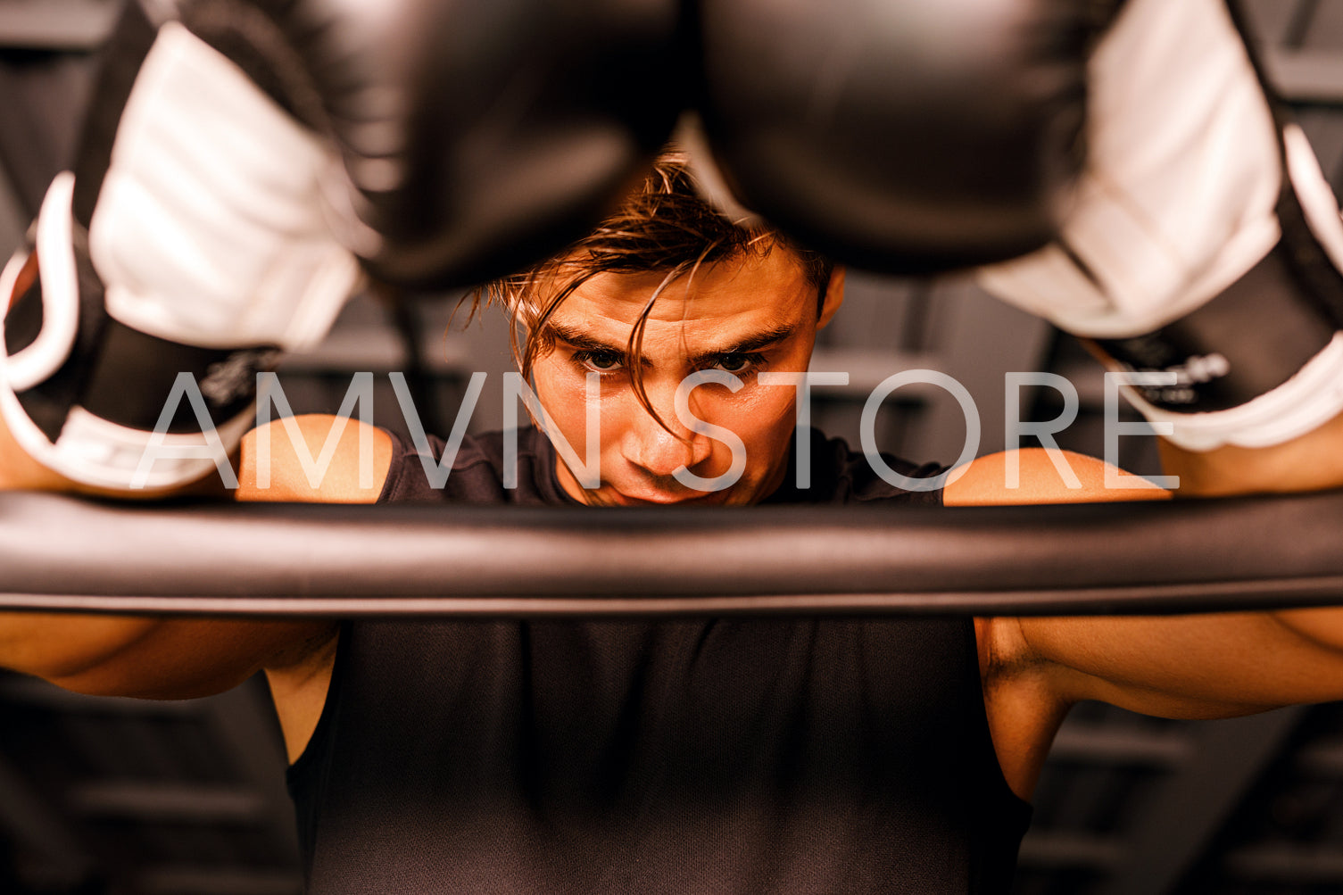 Tired boxer taking a break after a practice in gym	