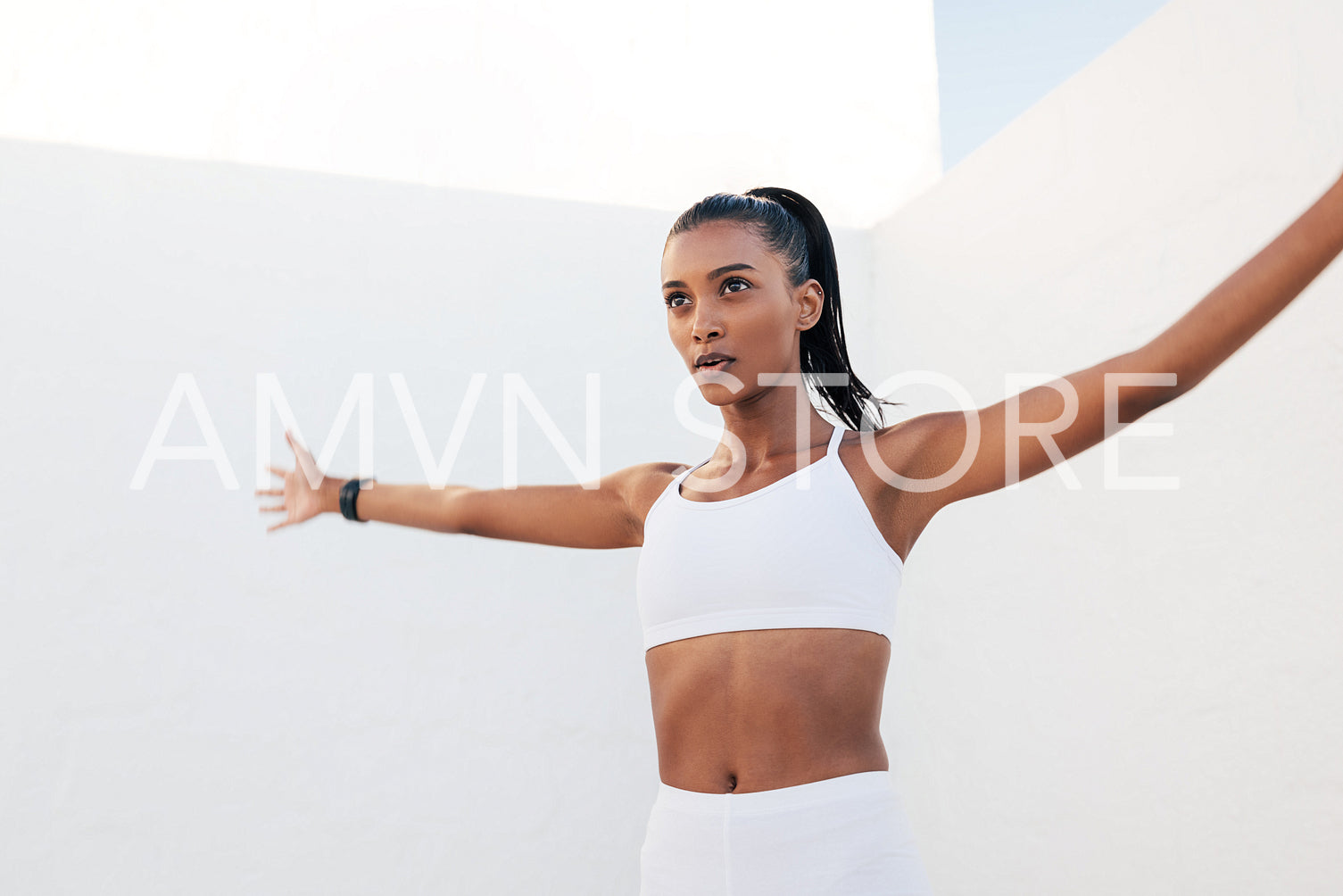 Woman jumping and waving her hands warming up before training