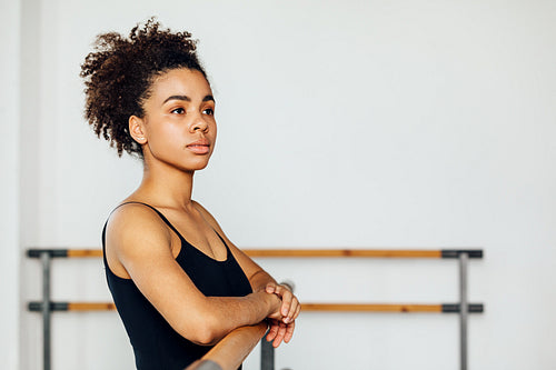 Portrait of a professional ballet dancer looking away while standing in a studio