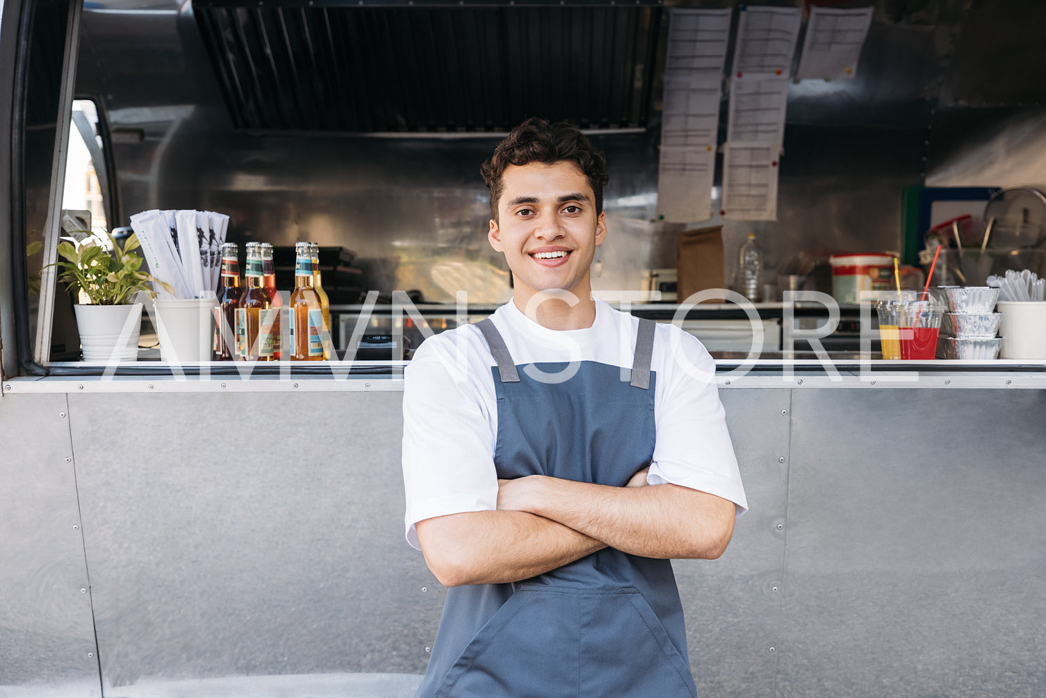 Portrait of a confident entrepreneur. Food truck owner wearing apron standing with crossed arms.