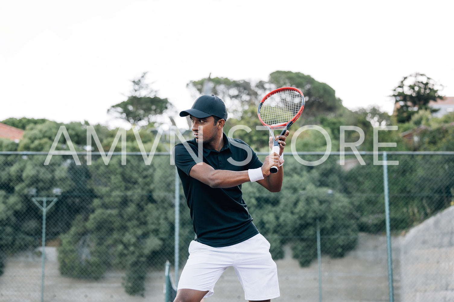 Tennis player with racket practicing at outdoor court