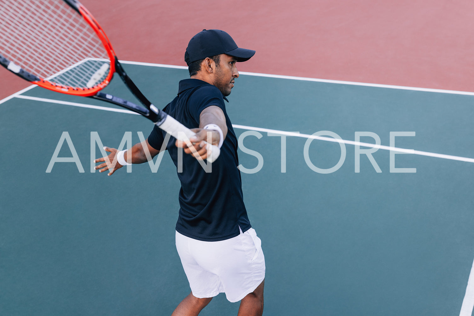 Professional tennis player practicing one-handed backhand hit on hard court