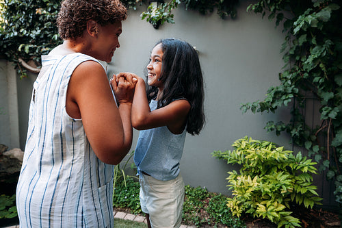 Girl and granny having fun together. Kid and grandmother looking at each other.