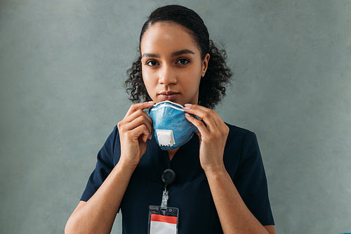 Nurse holding a protective mask