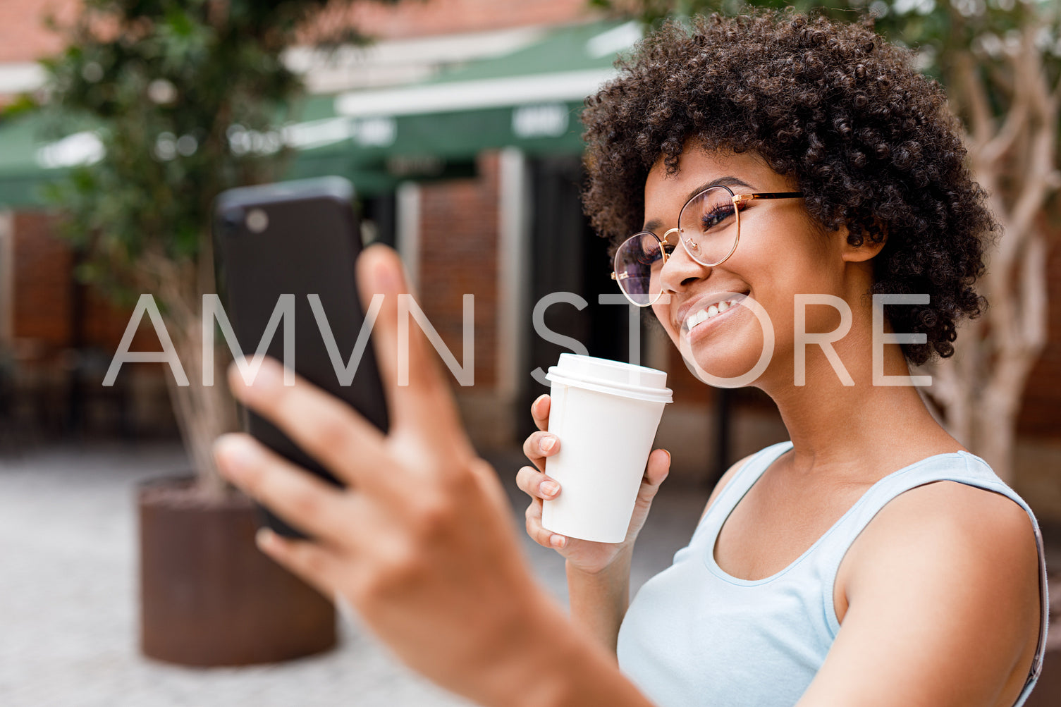 Social media influencer vlogging while drinking coffee to go	