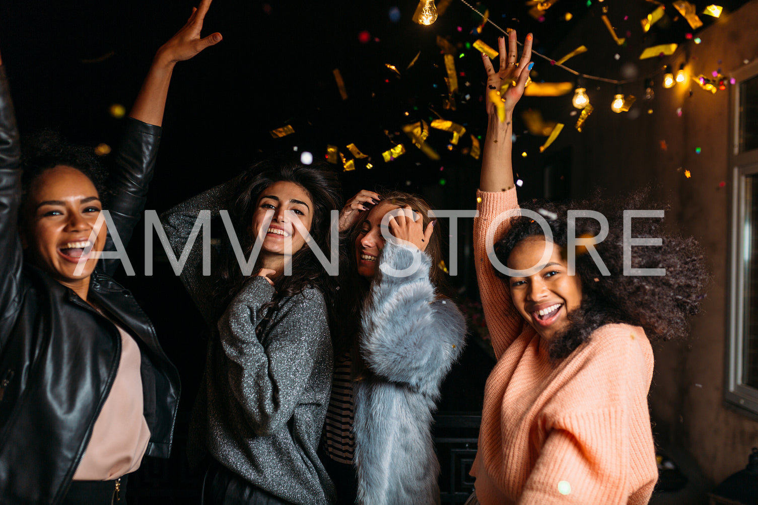 Group of young women hanging out together, dancing outdoors	