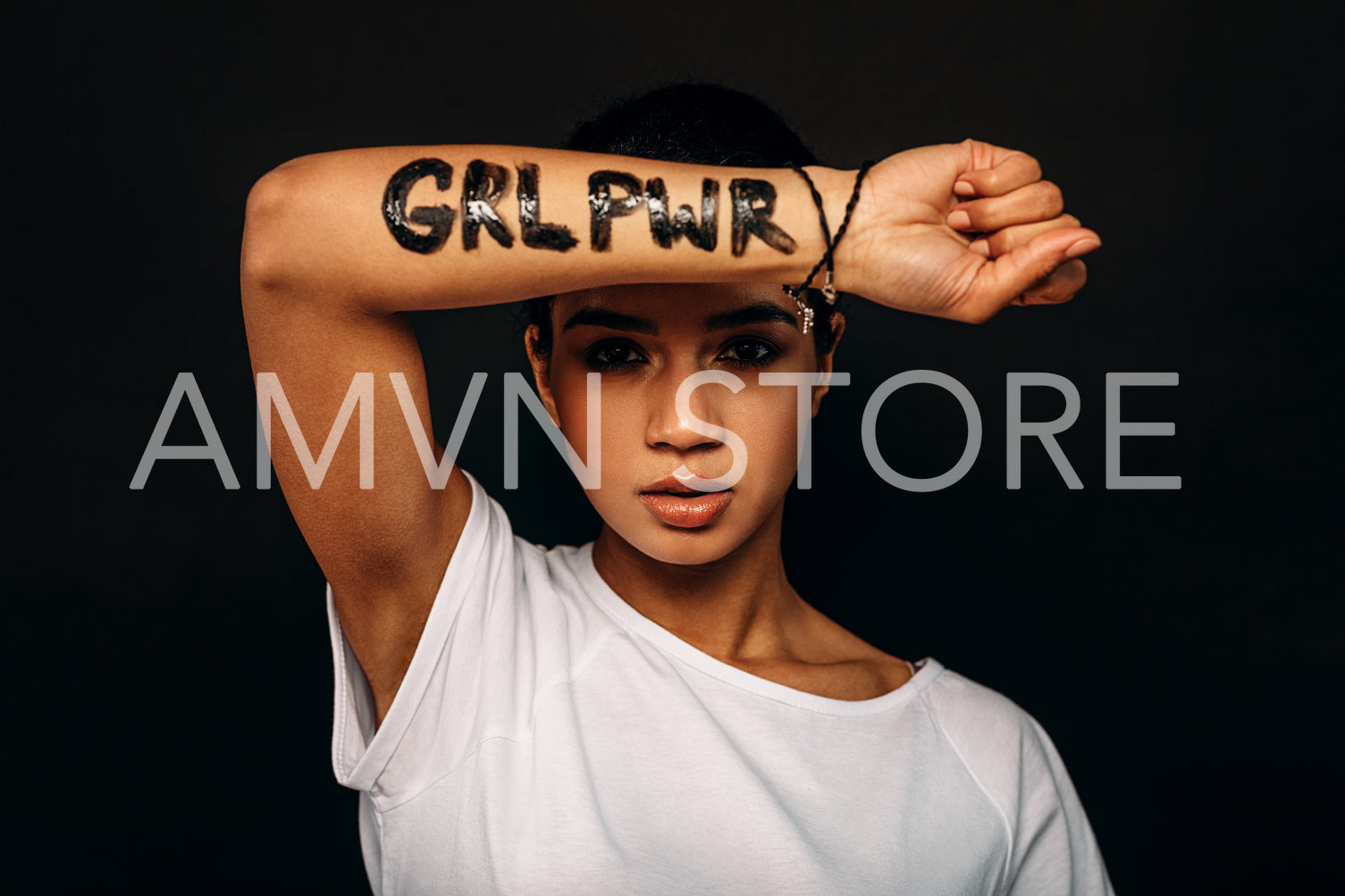 Young woman showing letters "GRL PRW" written on her hand	