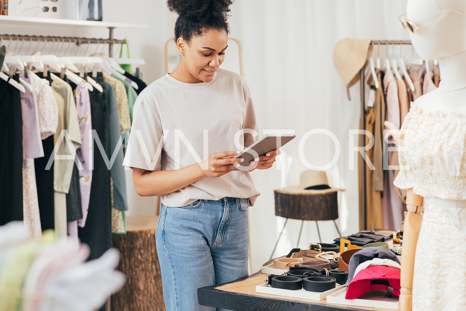 Woman business owner with digital tablet in a boutique. Saleswoman working in a retail store. 