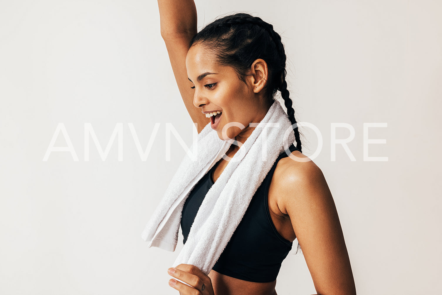 Side view of a happy mixed-race woman with a white towel around her neck	