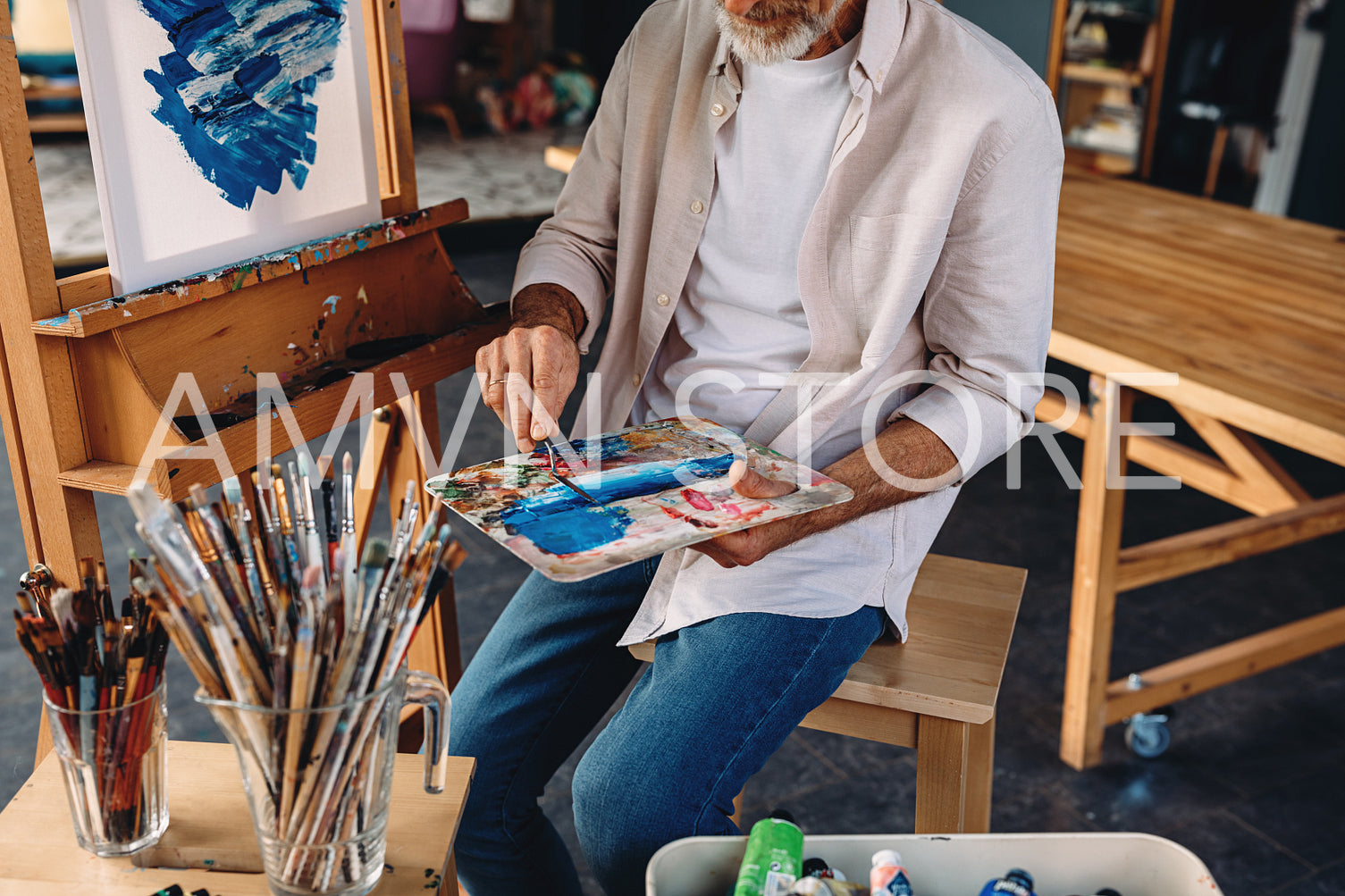 Unrecognizable artist holding a palette and a painting knife	