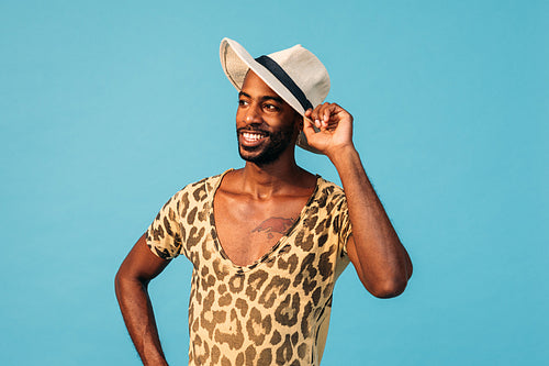 Portrait of a stylish African American guy against blue background