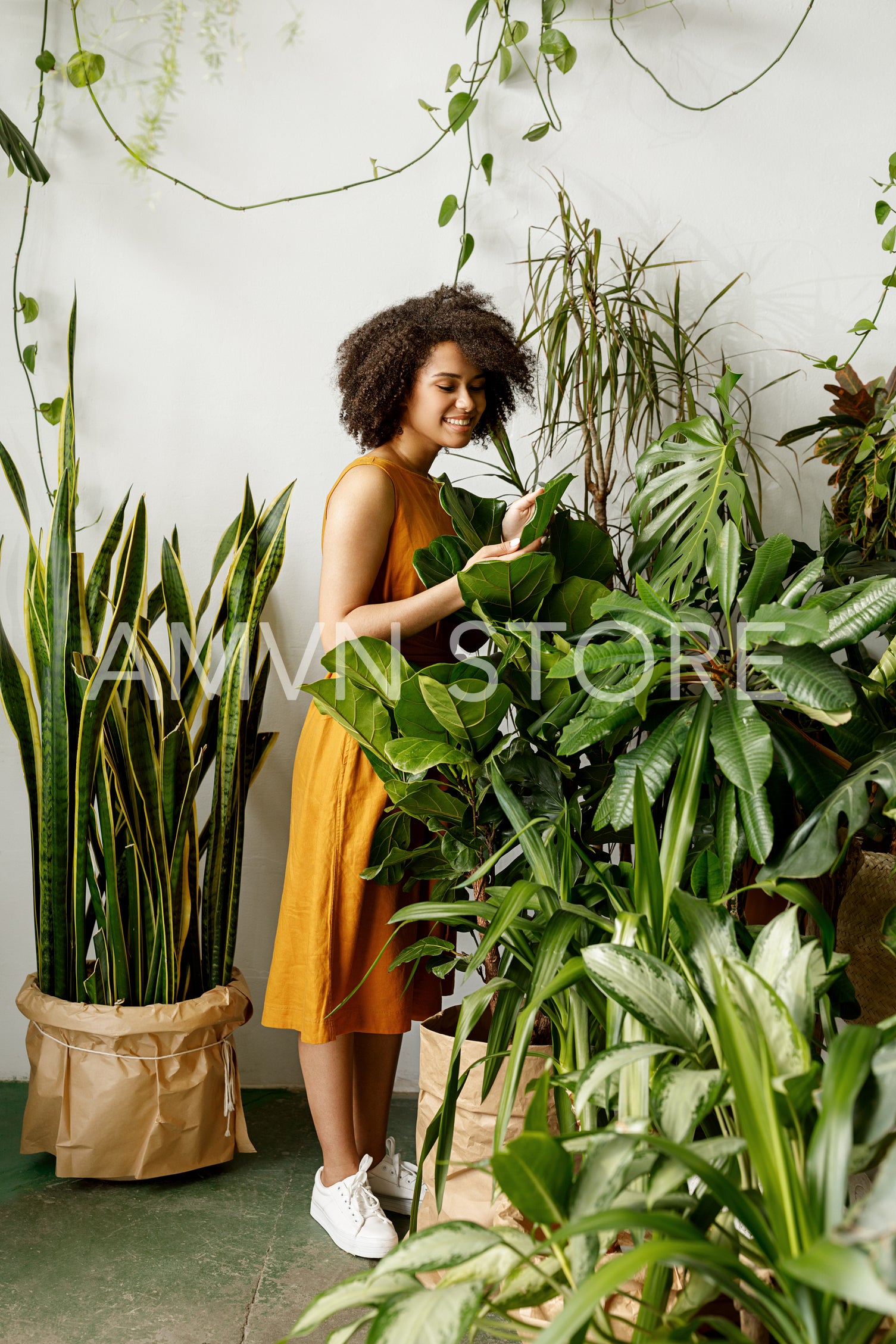 Beautiful woman botanist working at her indoor garden	