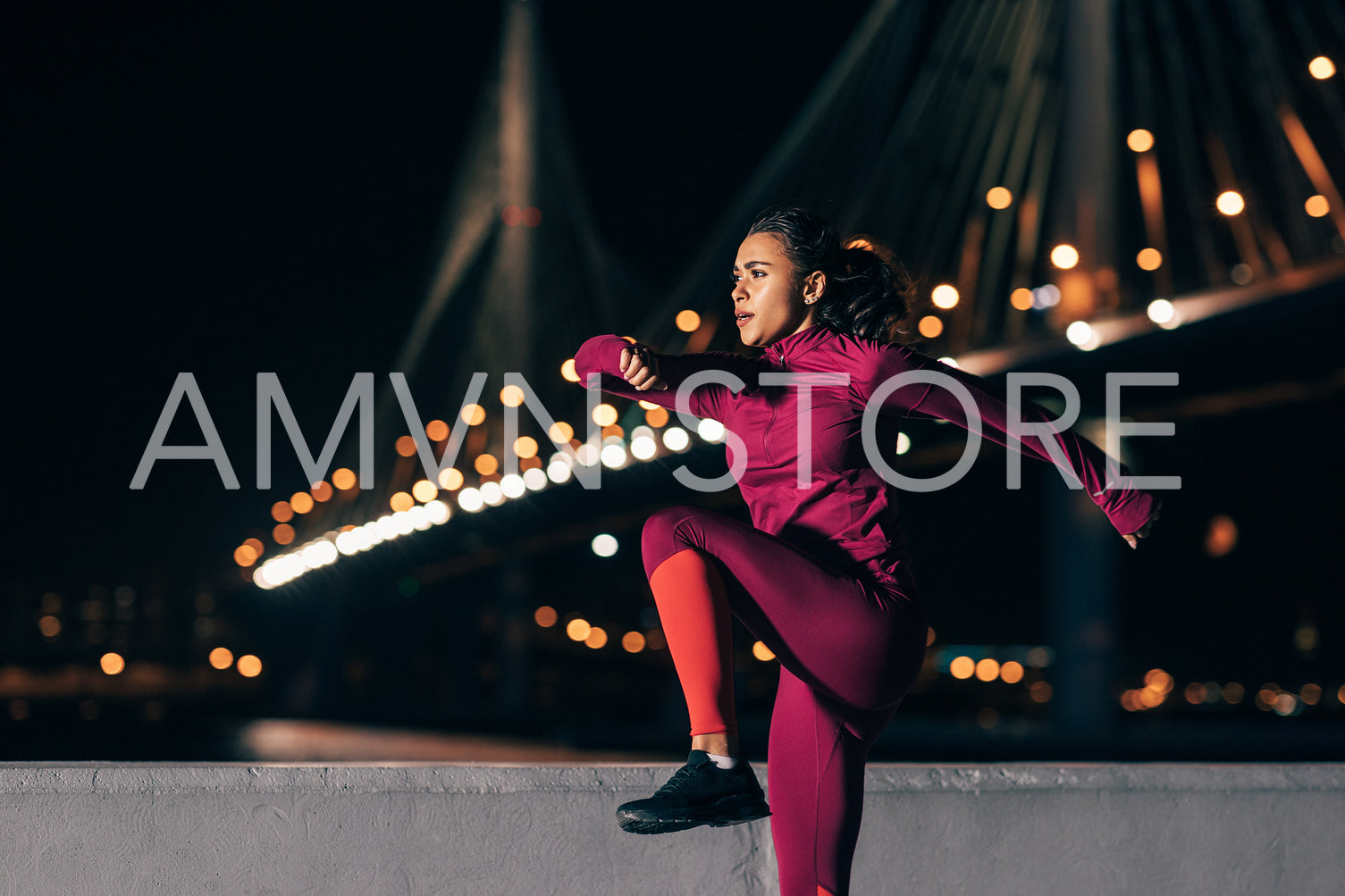 Fit woman doing warming up exercises at night outdoors