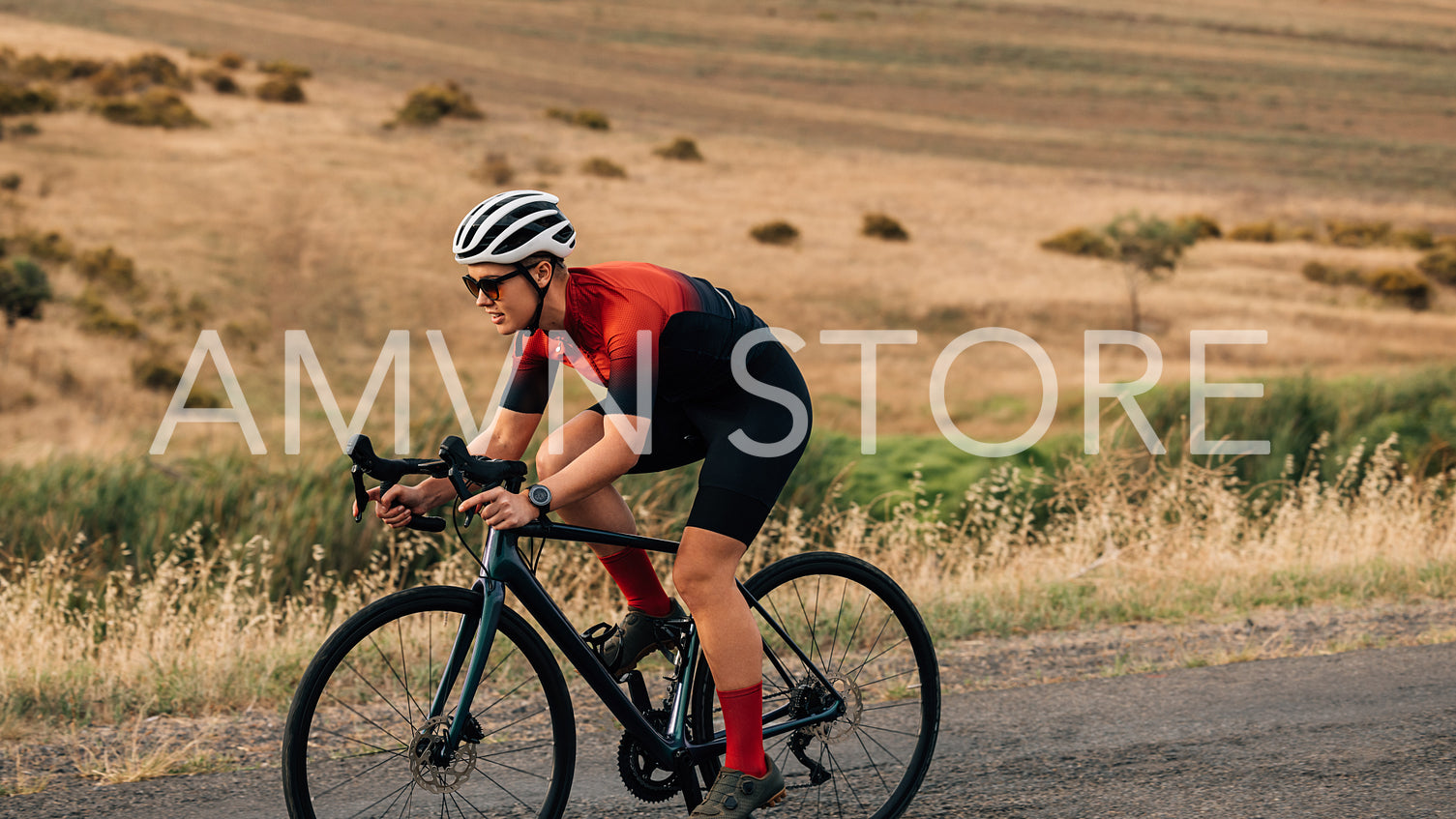 Road bike cyclist riding on pro bike outdoors on countryside road