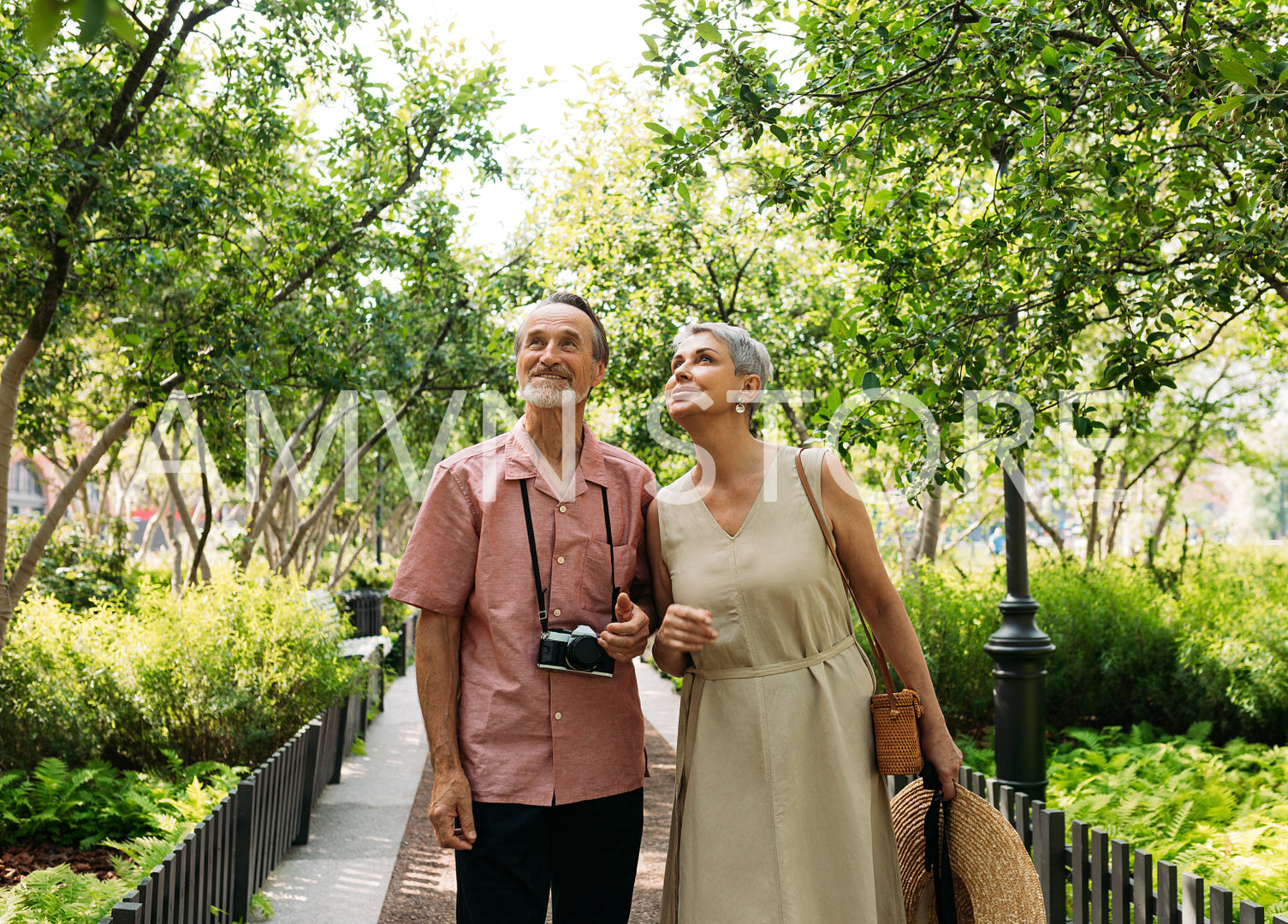 Two senior tourists walking in the park 