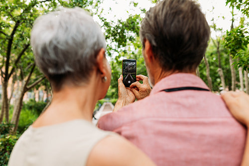 Senior couple taking a street photo