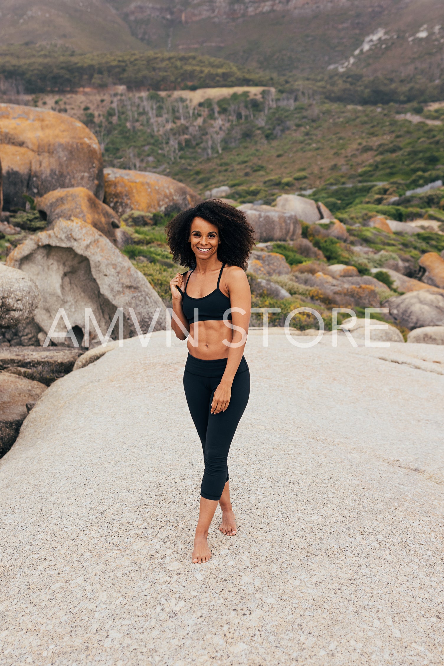 Fit woman in sportswear standing outdoors after yoga training ho