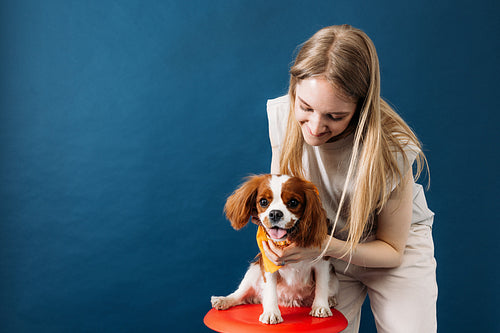 Studio portrait of a young woman with her little dog