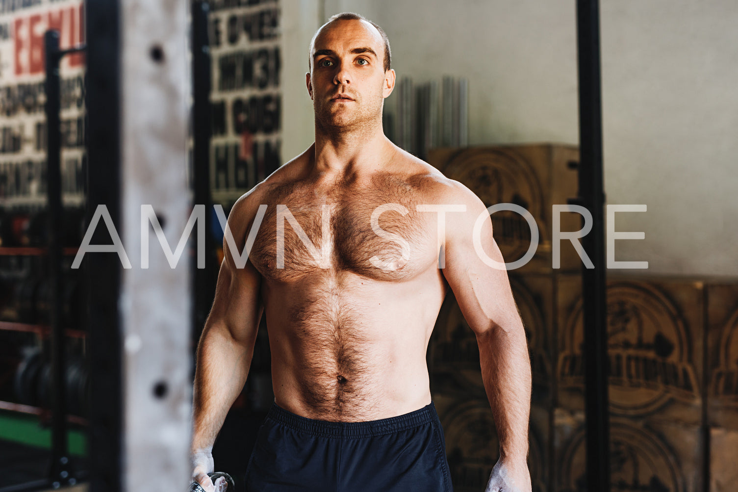 Portrait of a young bodybuilder resting during workout in gym	