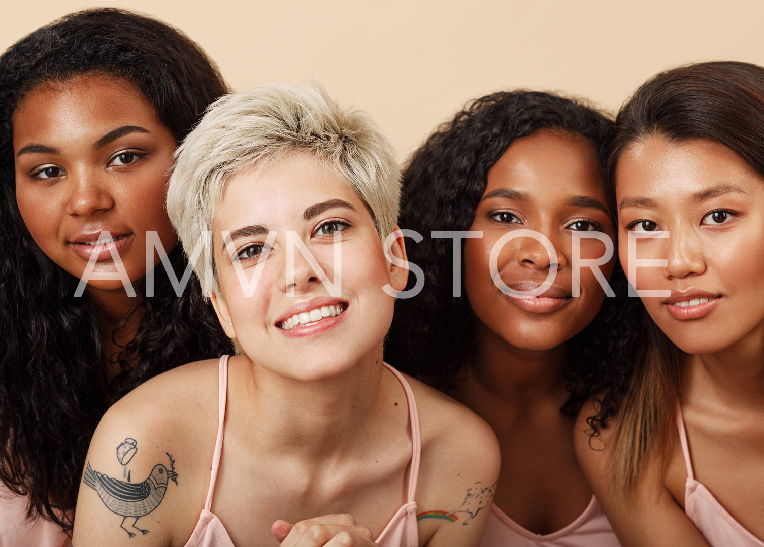 Group portrait of four diverse women in the studio. Female with different skin colors sitting together.