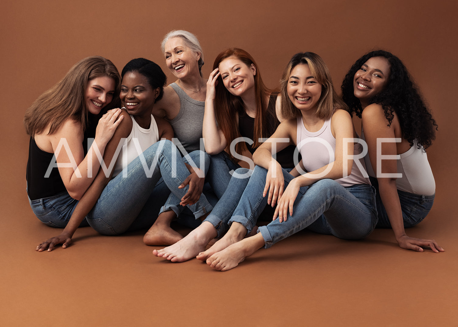 Six women of different ages sitting together in studio on brown background. Multi-ethnic group of diverse females having good times.