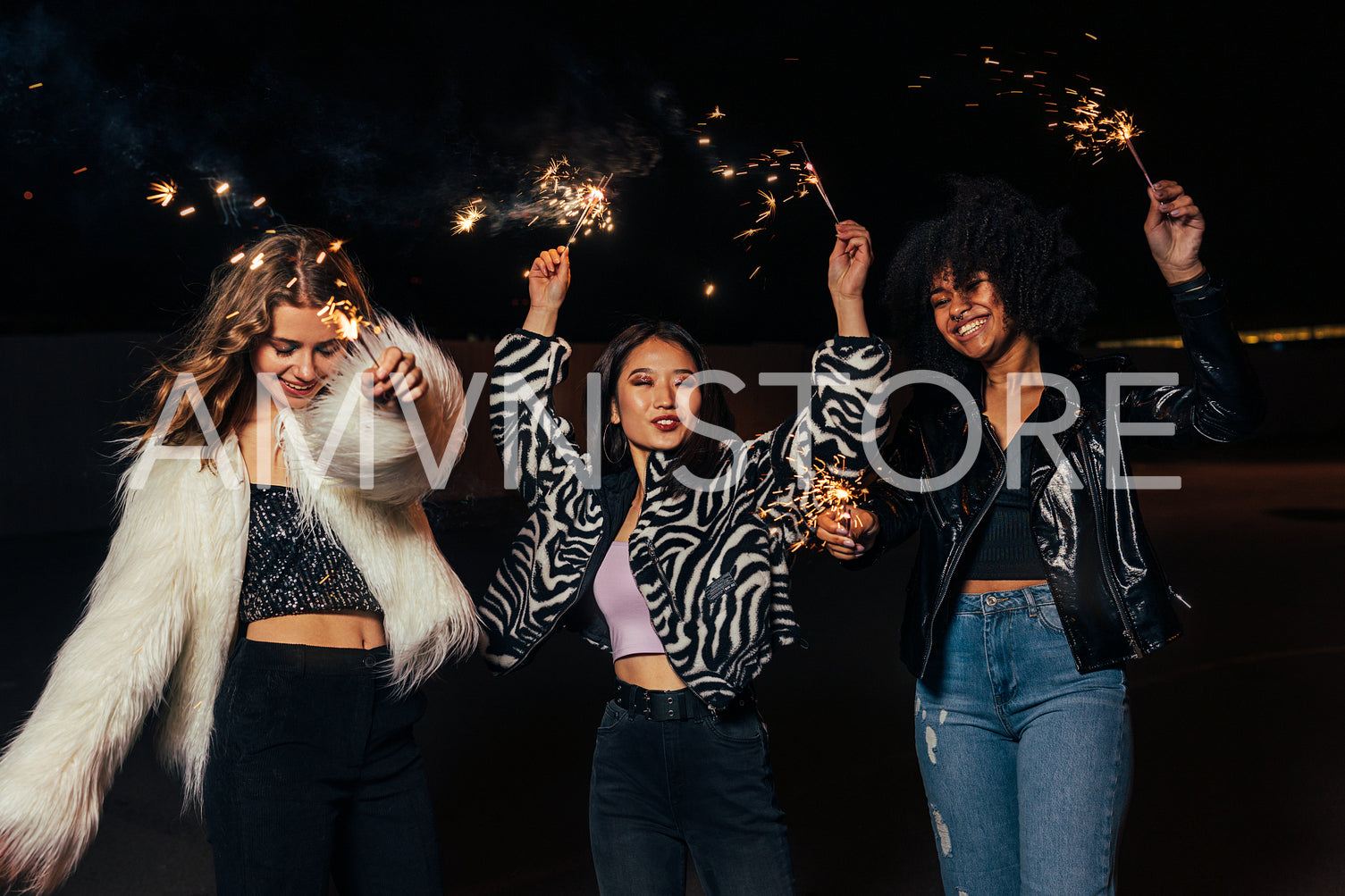 Happy stylish girls walking together at night and having fun	