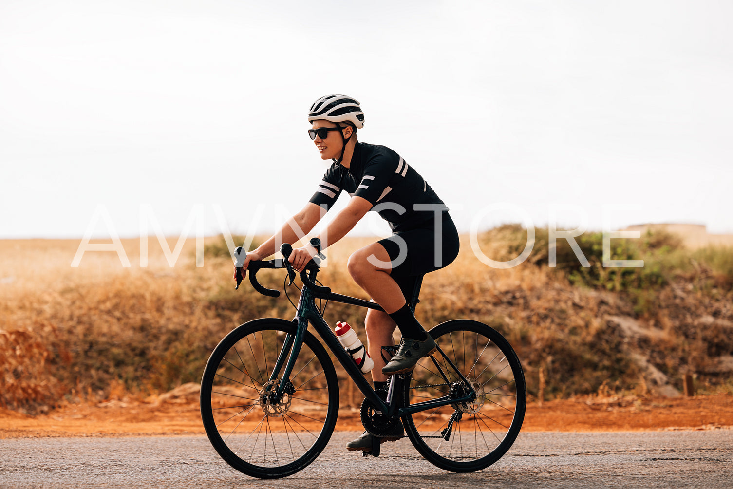 Side view of professional woman cyclist riding her bike outdoors