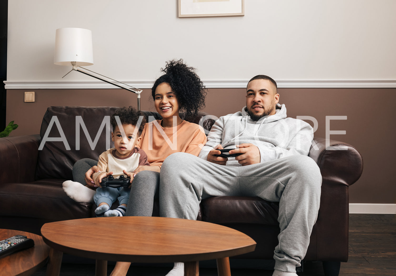 Mother, father, and little son spending time together at home playing video games