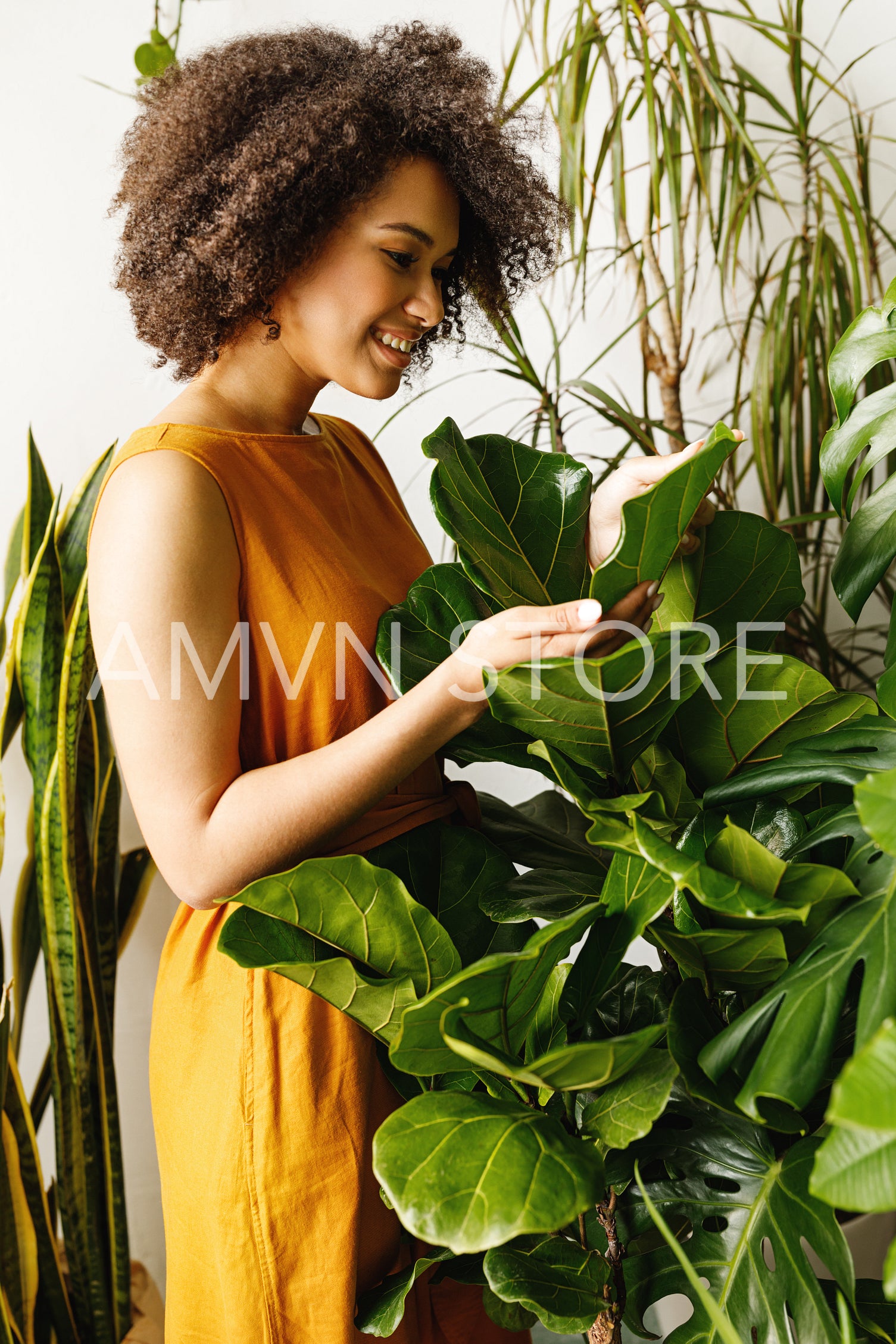 Side view of woman gardener working with plants at her workshop	