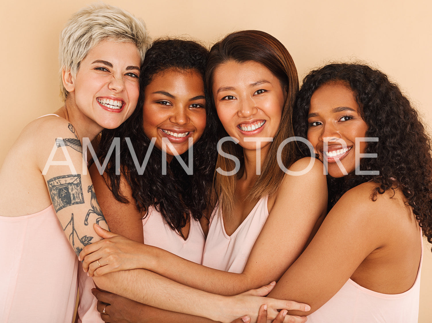 Four smiling diverse women embracing each other. Group of happy females of different races.