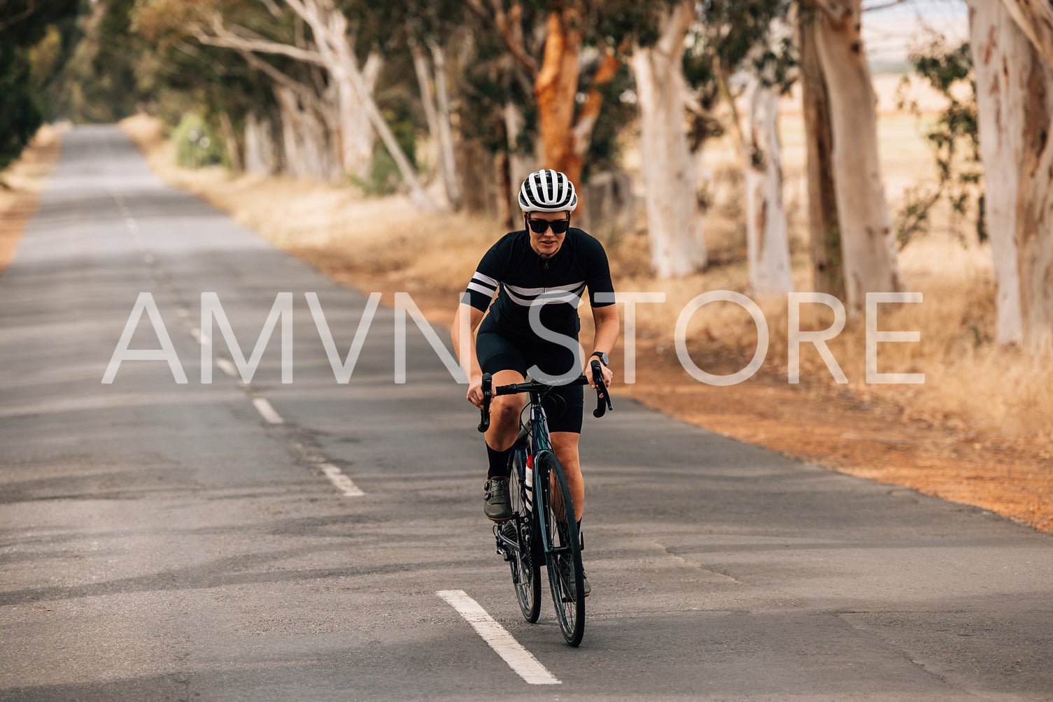 Professional cyclist riding her bike on empty road